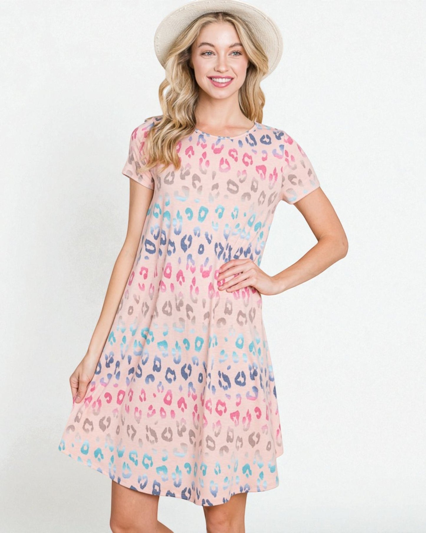 Woman wearing a pastel leopard print dress on a white background