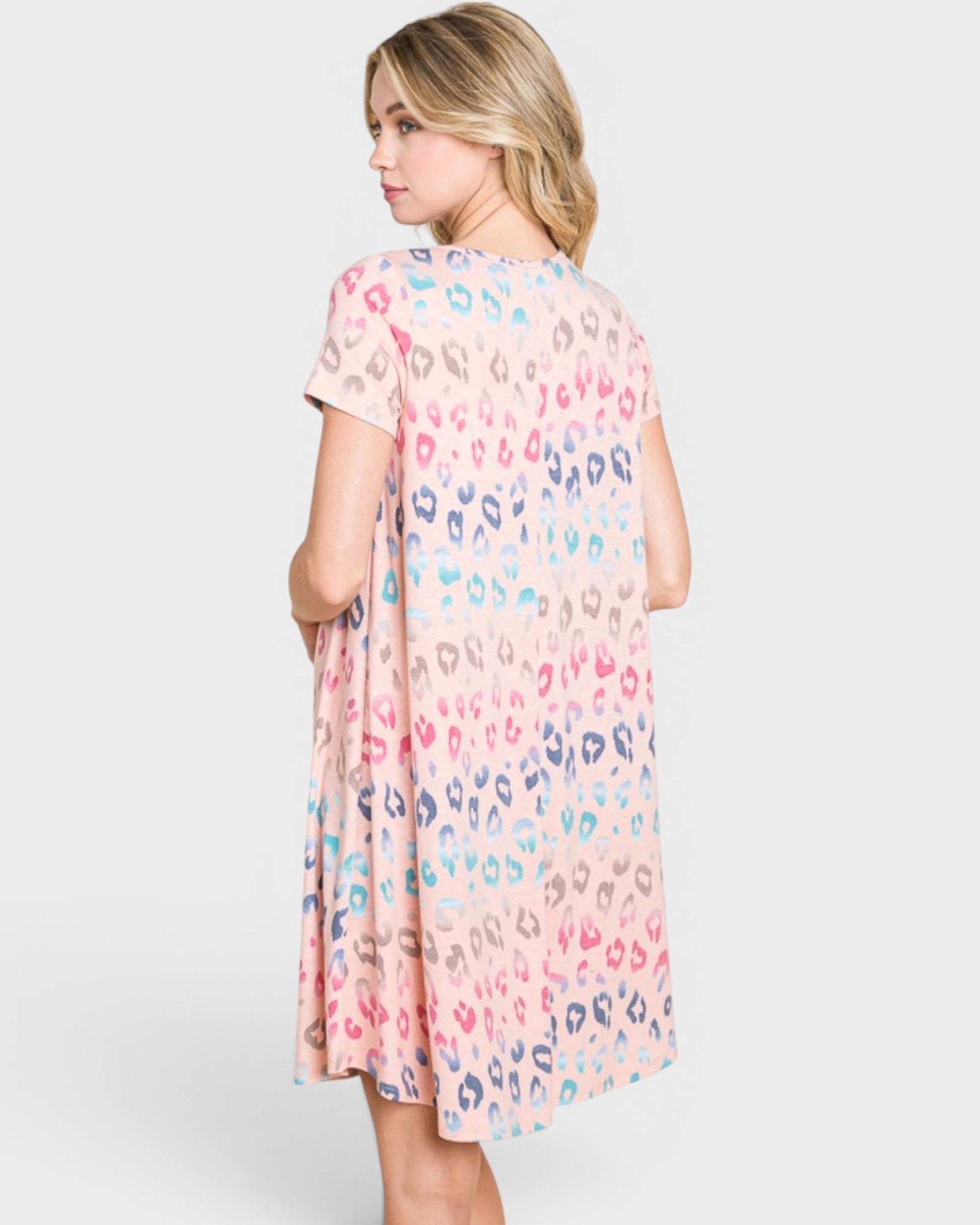 Woman wearing a patterned dress on a white background