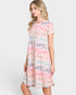 Woman wearing a pastel leopard print dress on a white background