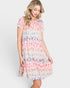 Woman wearing a pink dress with multicolor animal print on a white background