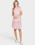 Woman wearing a patterned dress on a white background