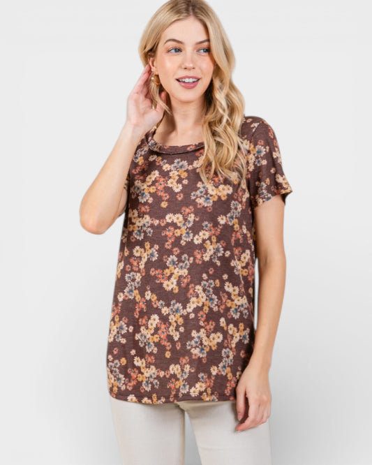 Woman wearing a brown floral t-shirt on a white background