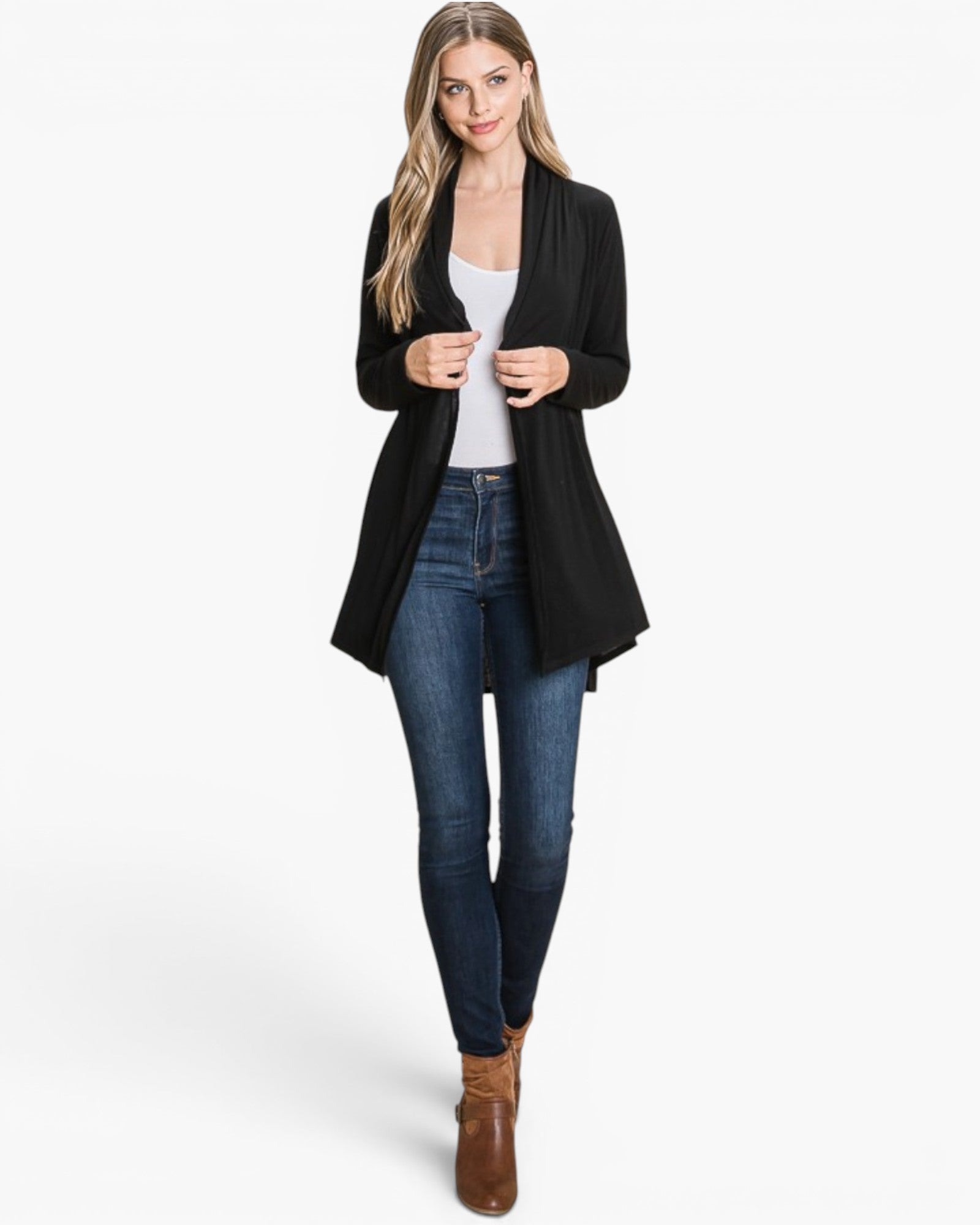 A woman modeling a black open-front cardigan over a white top, blue skinny jeans, and brown ankle boots, photographed against a clean white studio background.
