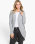 A woman modeling a light gray open-front cardigan over a white top and black jeans, photographed against a plain light gray studio background.