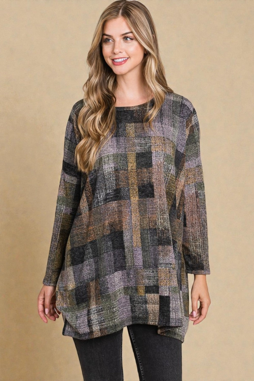 Woman wearing a plaid patterned dress against a beige background