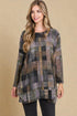 Woman wearing a plaid patterned dress against a beige background