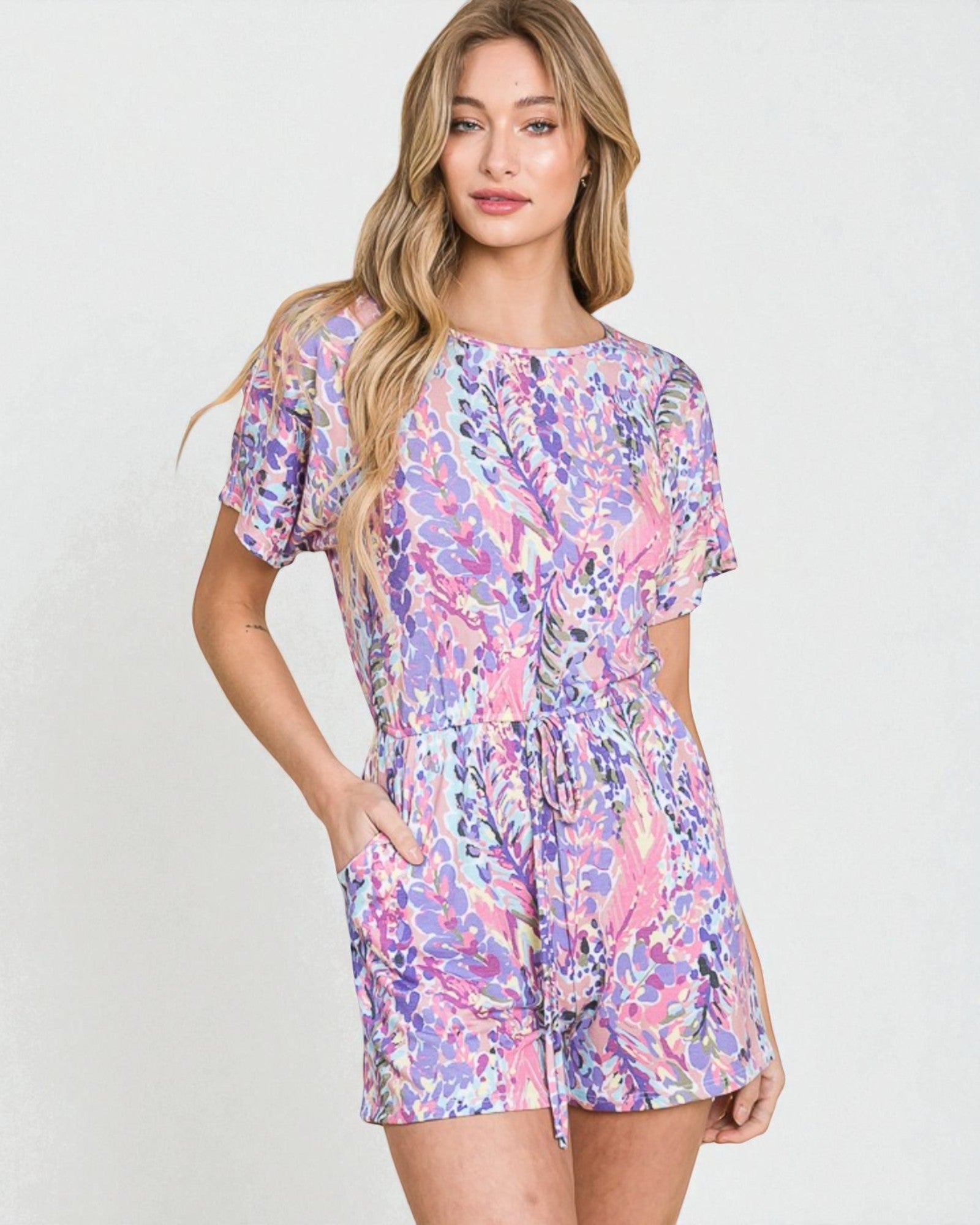 Woman wearing a colorful floral dress on a white background