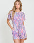 Woman wearing a colorful floral dress on a white background