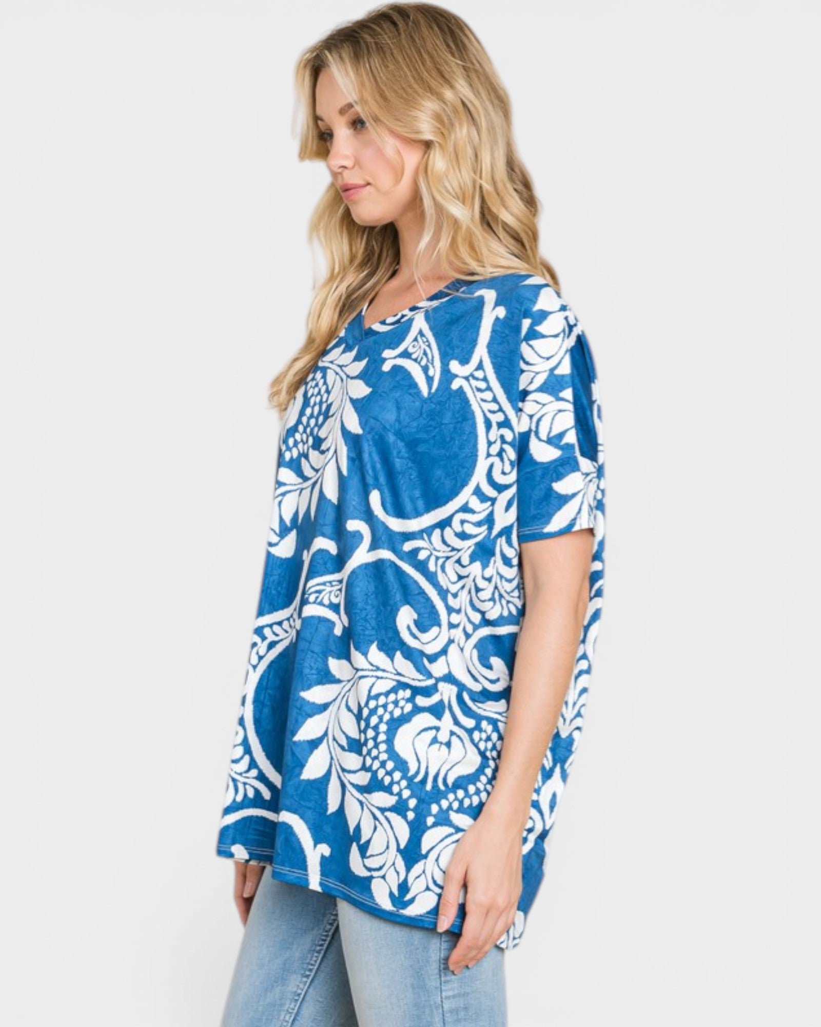 Woman wearing a blue and white patterned top on a white background