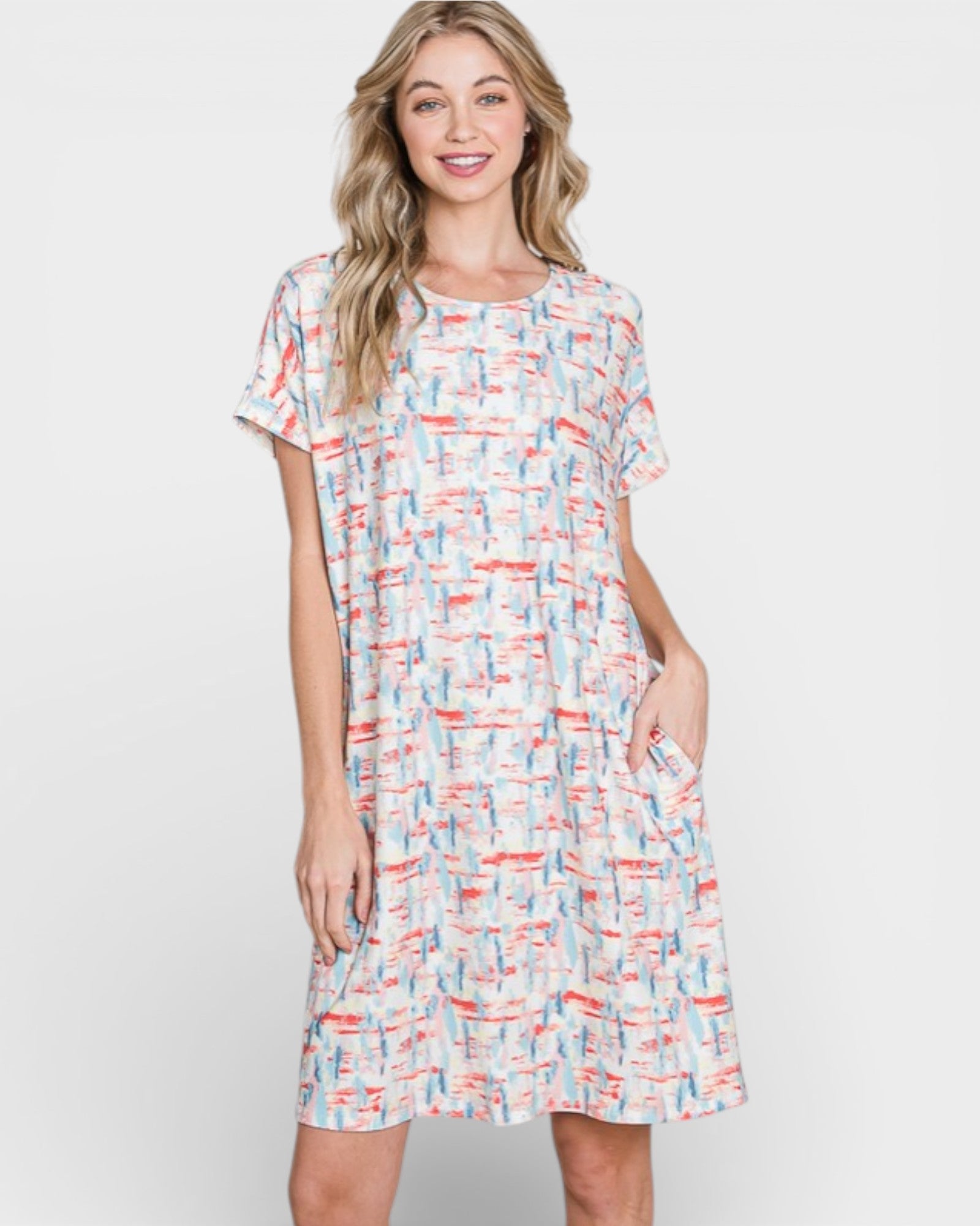 Woman wearing a colorful patterned dress on a white background