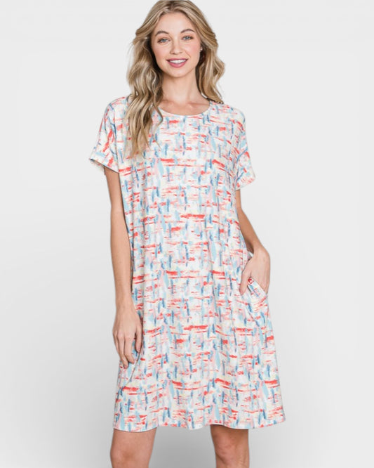 Woman wearing a colorful patterned dress on a white background