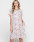 Woman wearing a colorful patterned dress on a white background