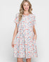 Woman wearing a patterned dress on a white background