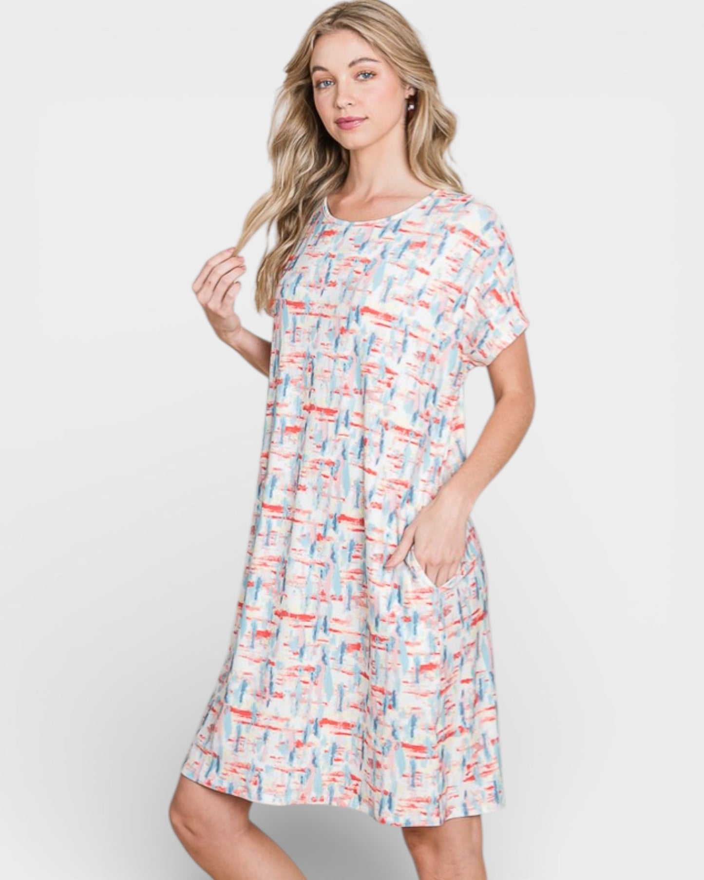 Woman wearing a patterned dress on a plain background