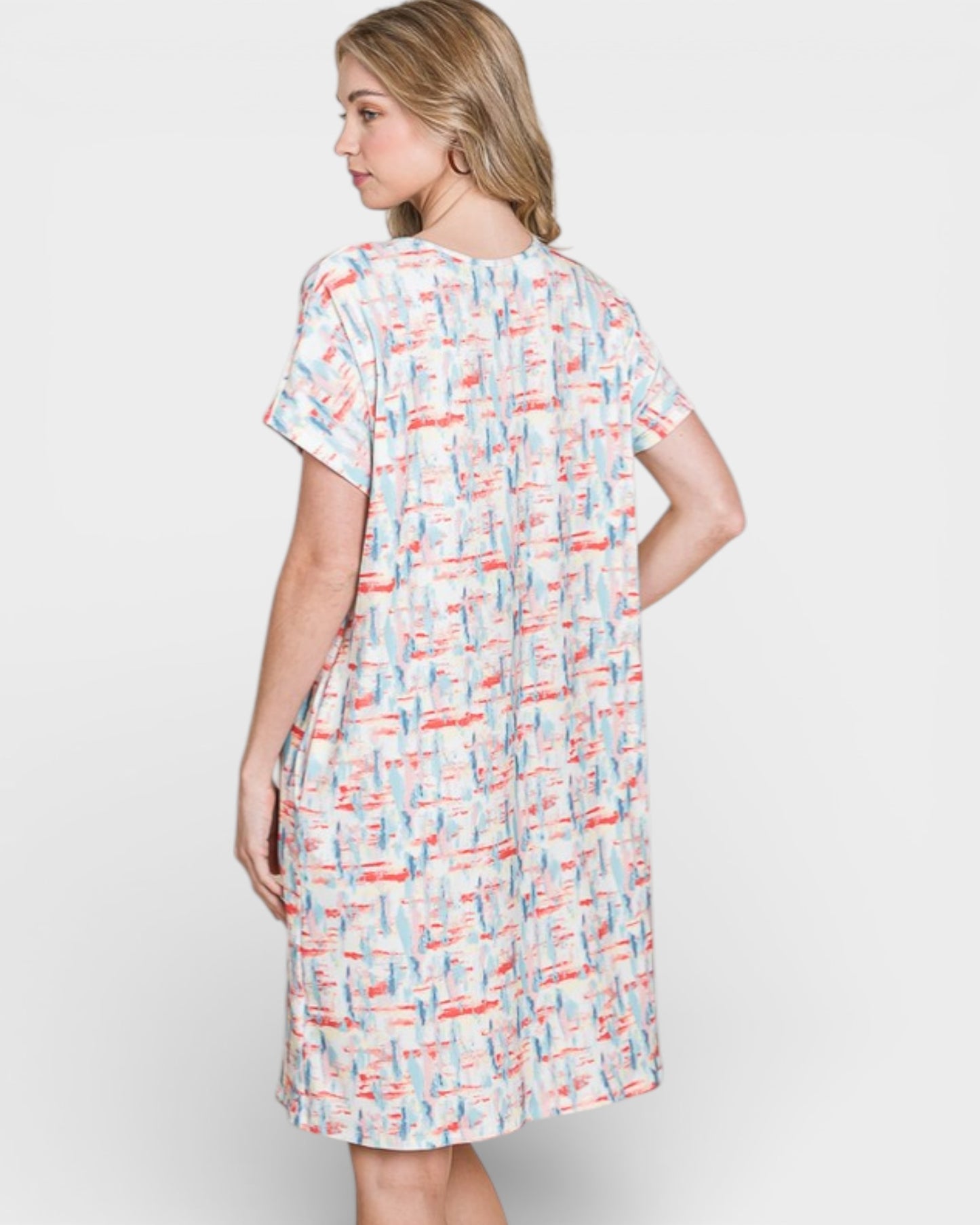 Woman wearing a patterned dress on a white background