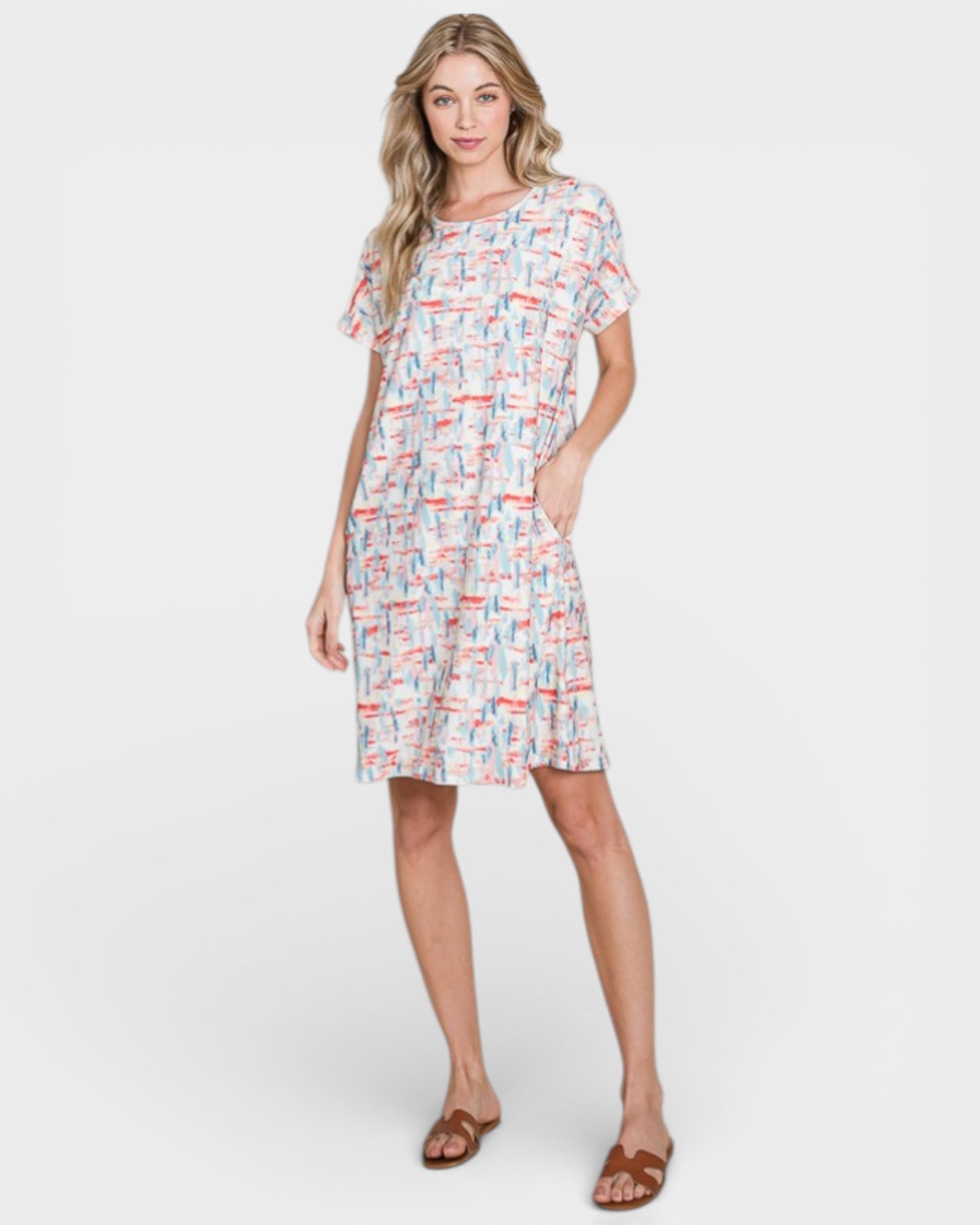 Woman wearing a patterned dress on a white background