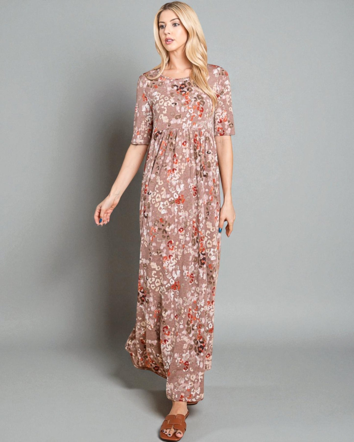 Woman wearing a floral dress on a gray background