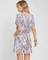 Woman wearing a floral dress on a white background