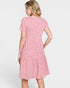 Woman wearing a pink floral dress on a white background