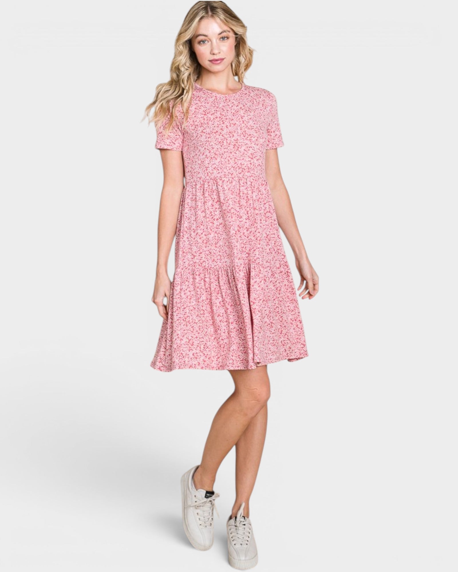 Woman wearing a pink floral dress on a white background