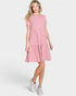Woman wearing a pink floral dress on a white background
