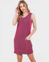 Woman wearing a sleeveless pink dress with pockets on a white background