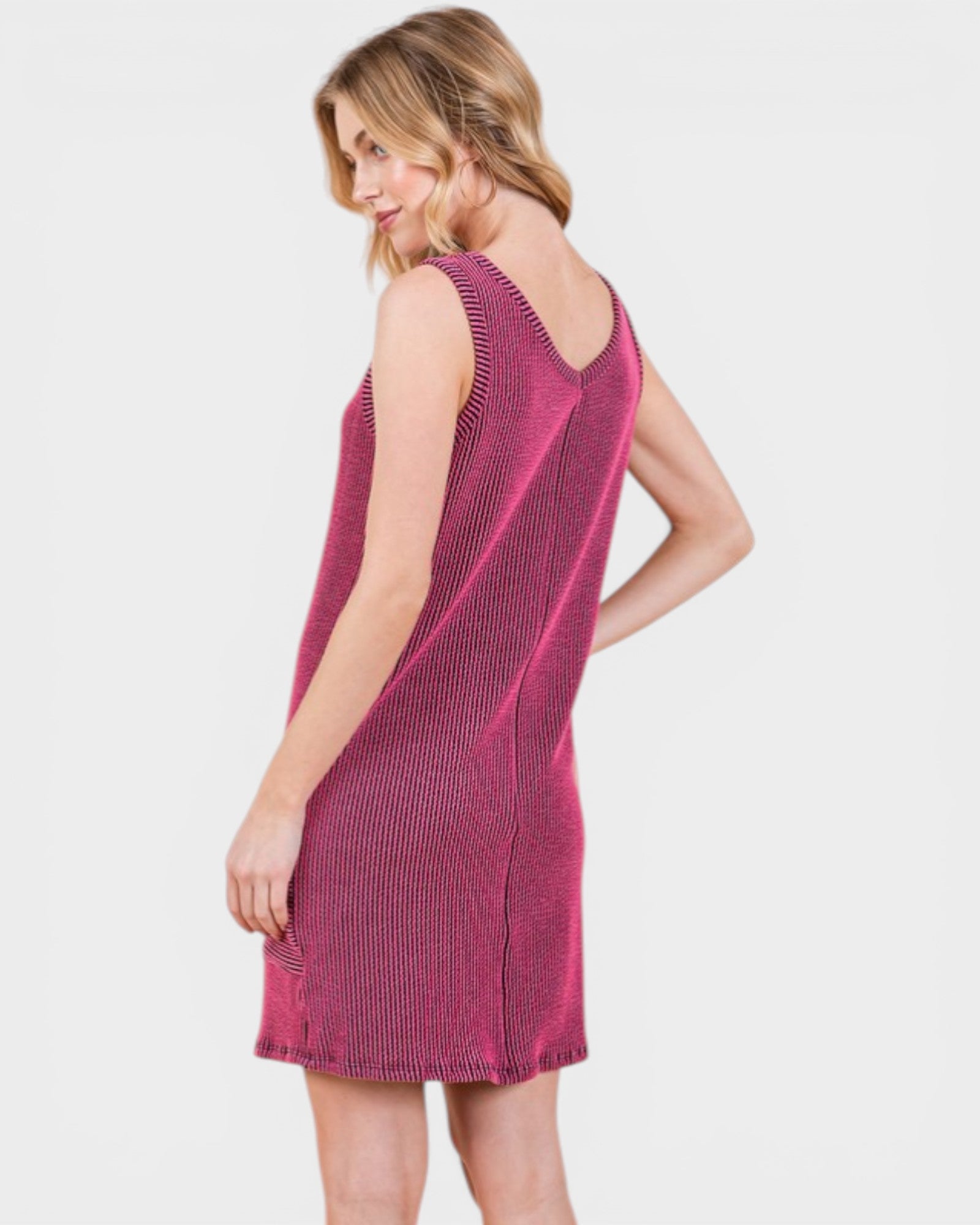 Woman wearing a pink sleeveless dress on a white background