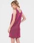 Woman wearing a pink sleeveless dress on a white background