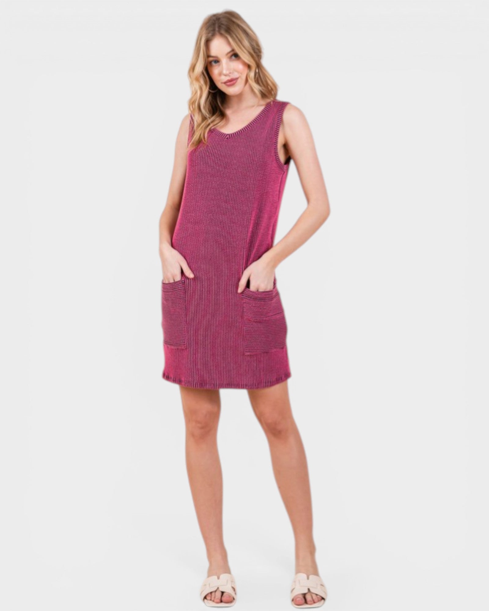 Woman wearing a pink sleeveless dress on a white background
