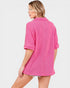 Woman wearing a pink ribbed sweater on a white background