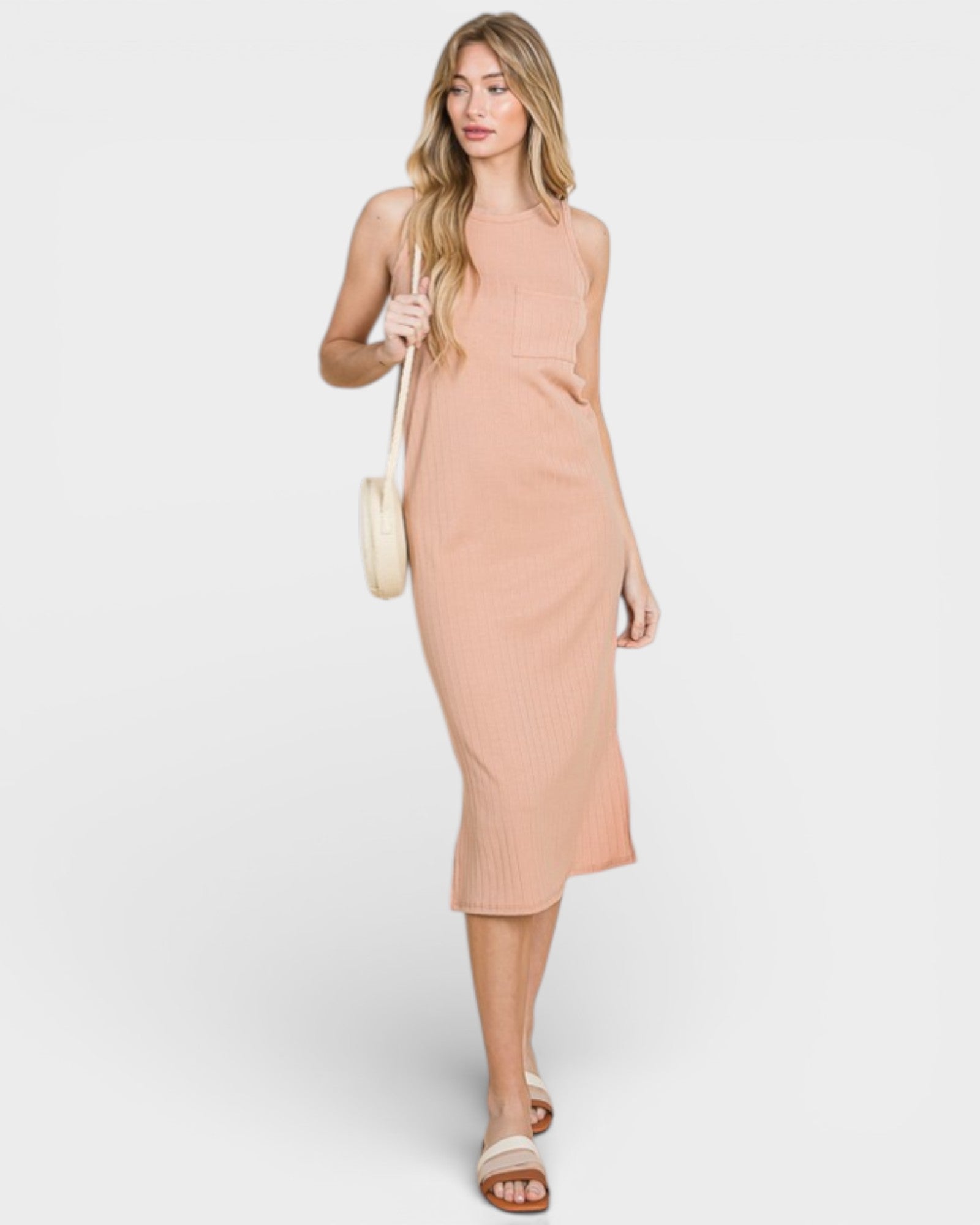 Woman wearing a peach dress against a white background