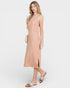 Woman wearing a light pink ribbed dress on a white background