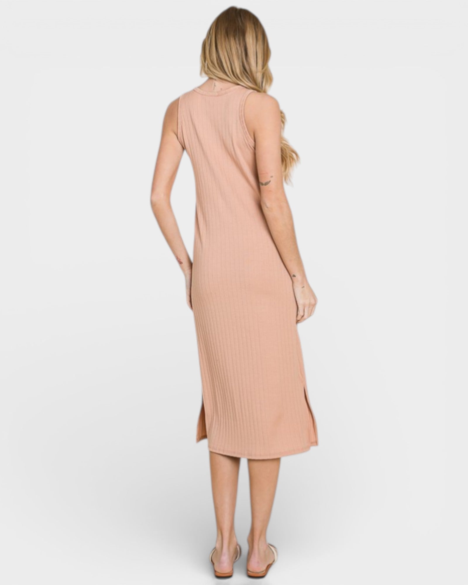 Woman wearing a beige sleeveless dress on a white background