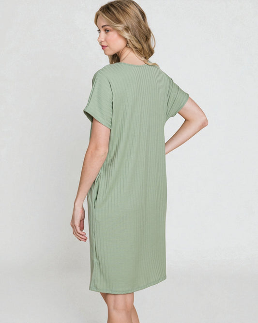 Woman wearing a green dress against a white background