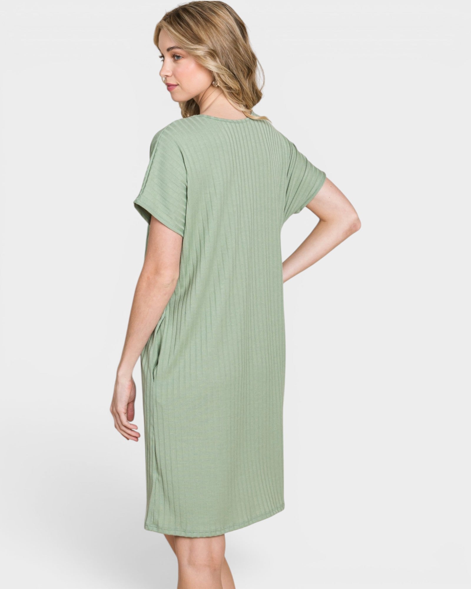 Woman wearing a green dress on a white background