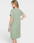 Woman wearing a green dress on a white background