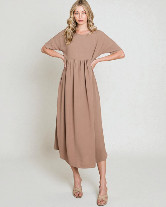 Woman wearing a brown dress against a white background