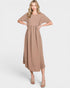 Woman wearing a beige dress on a white background