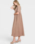 Woman wearing a long beige dress on a white background