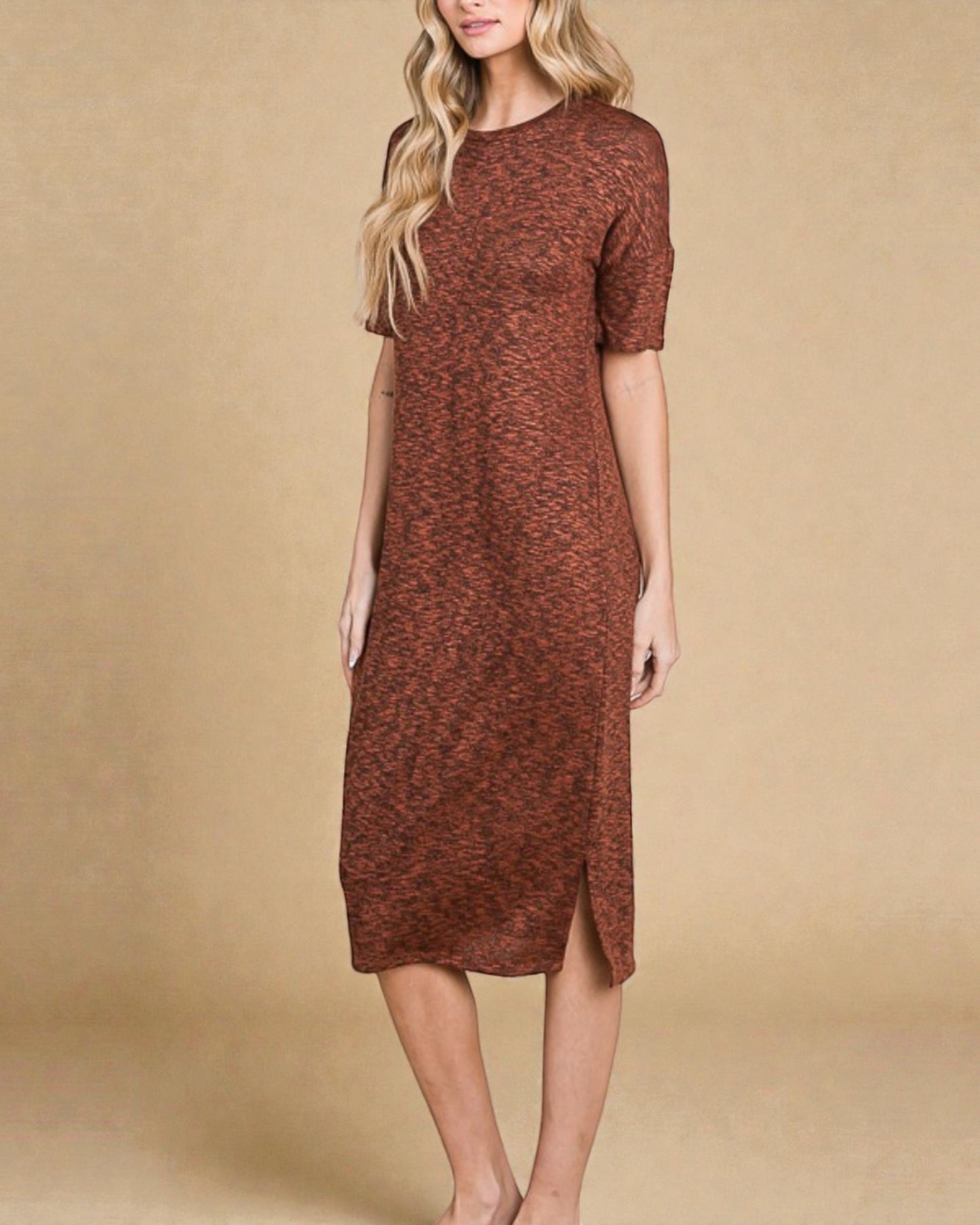 Woman wearing a brown patterned dress against a beige background