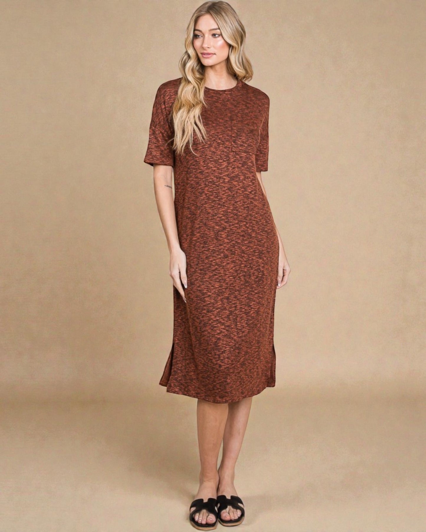 Woman wearing a brown dress against a beige background