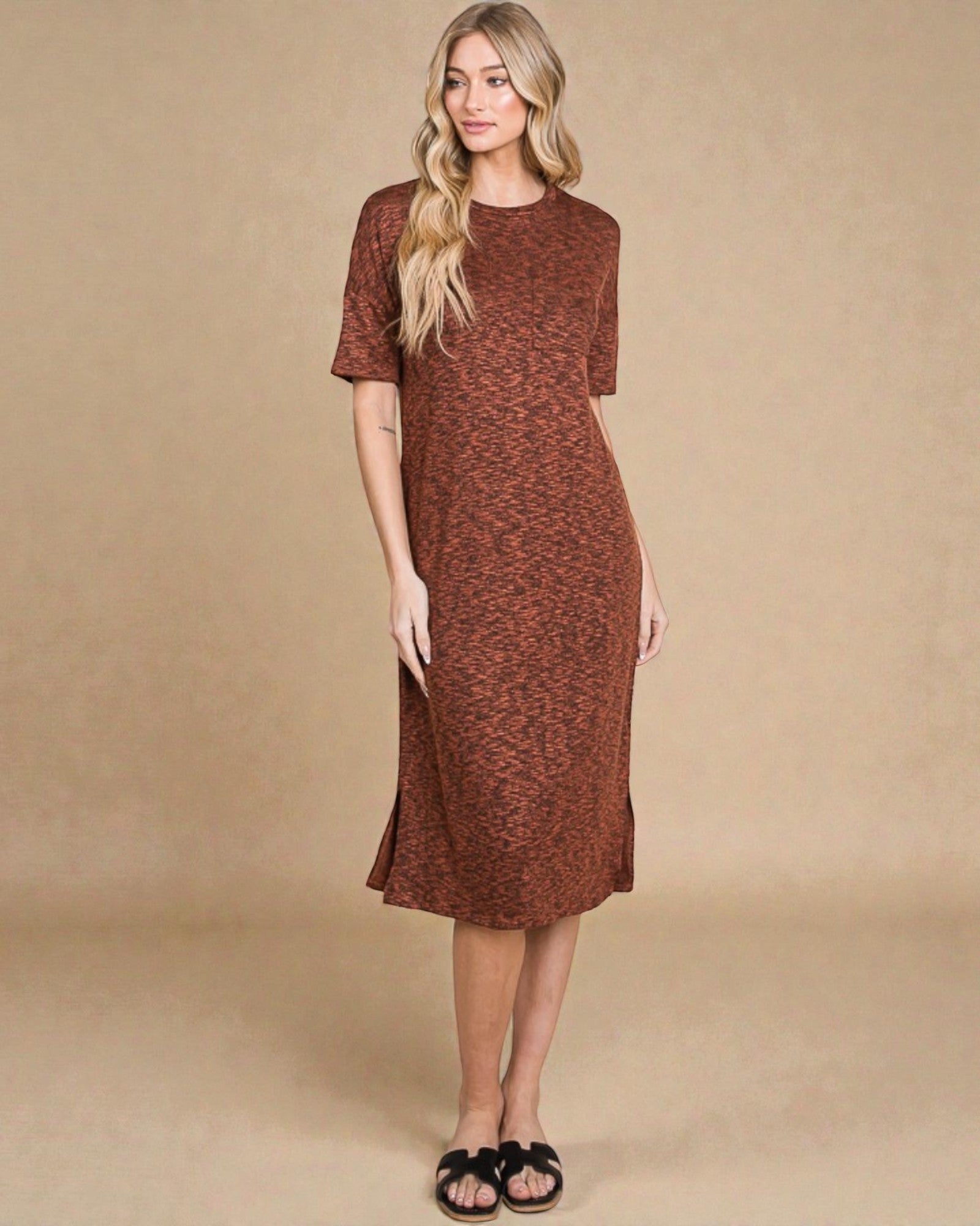 Woman wearing a brown dress against a beige background