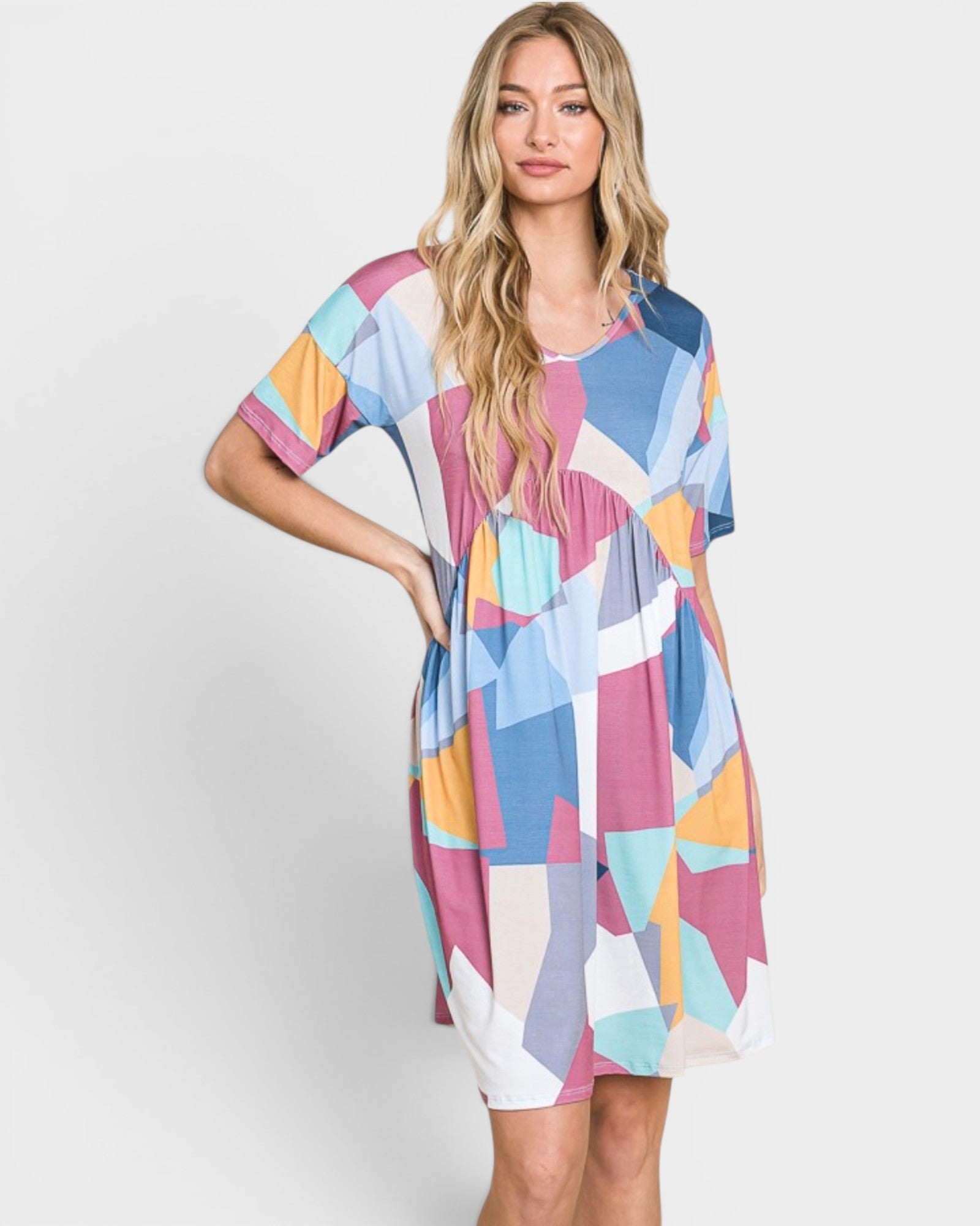 Woman wearing a colorful patterned dress on a white background