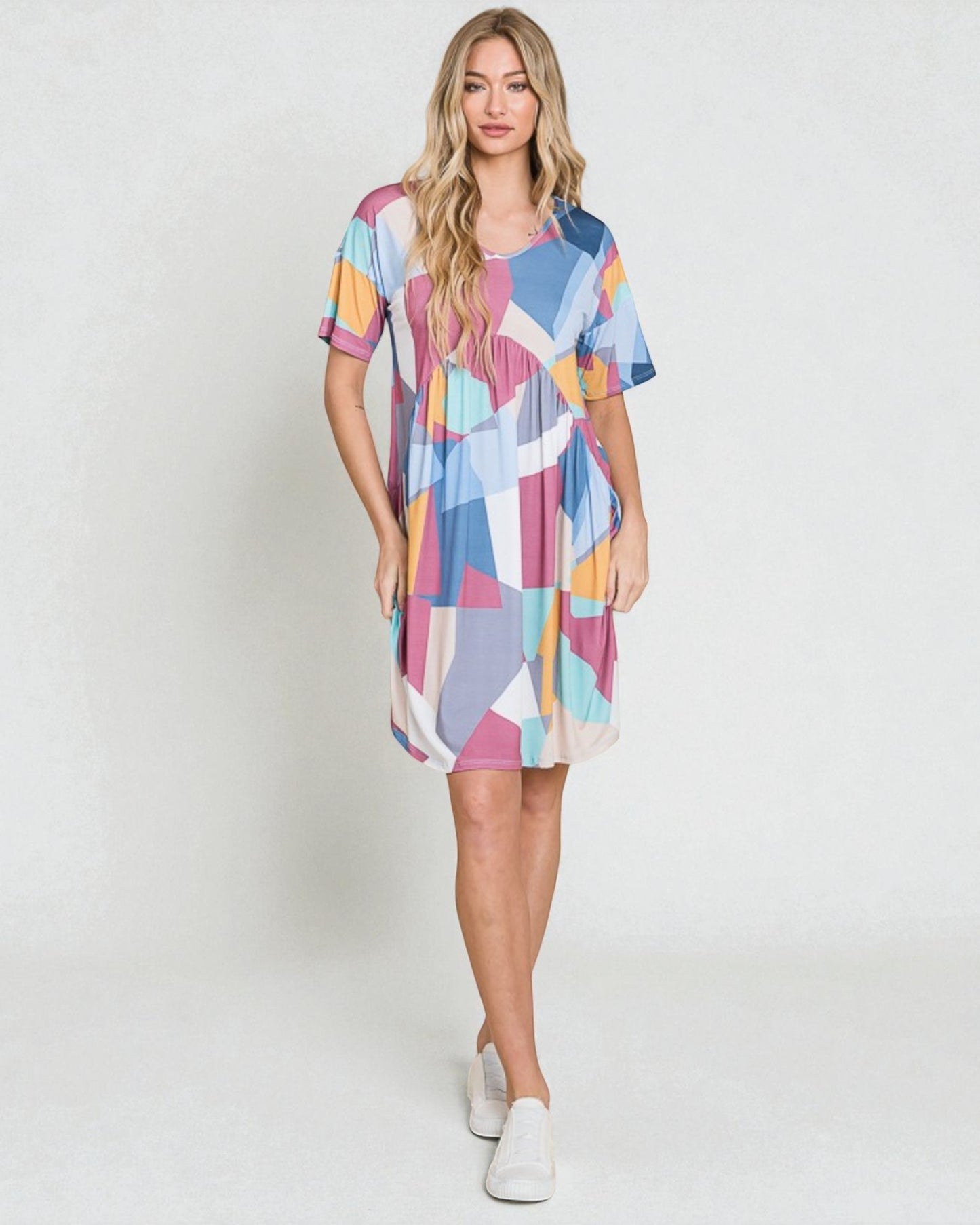 Woman wearing a colorful patterned dress on a white background