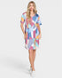 Woman wearing a colorful patterned dress on a white background