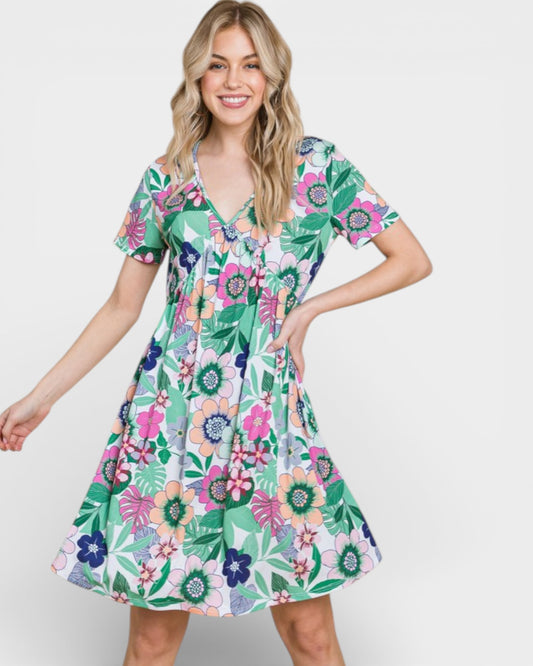 Woman wearing a colorful floral dress on a white background