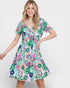 Woman wearing a colorful floral dress on a white background