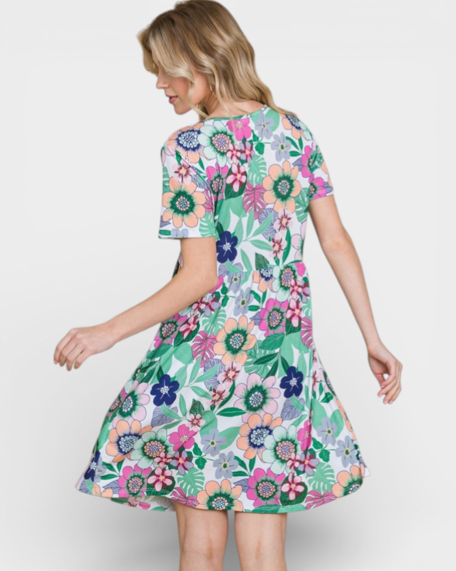 Woman wearing a colorful floral dress on a white background