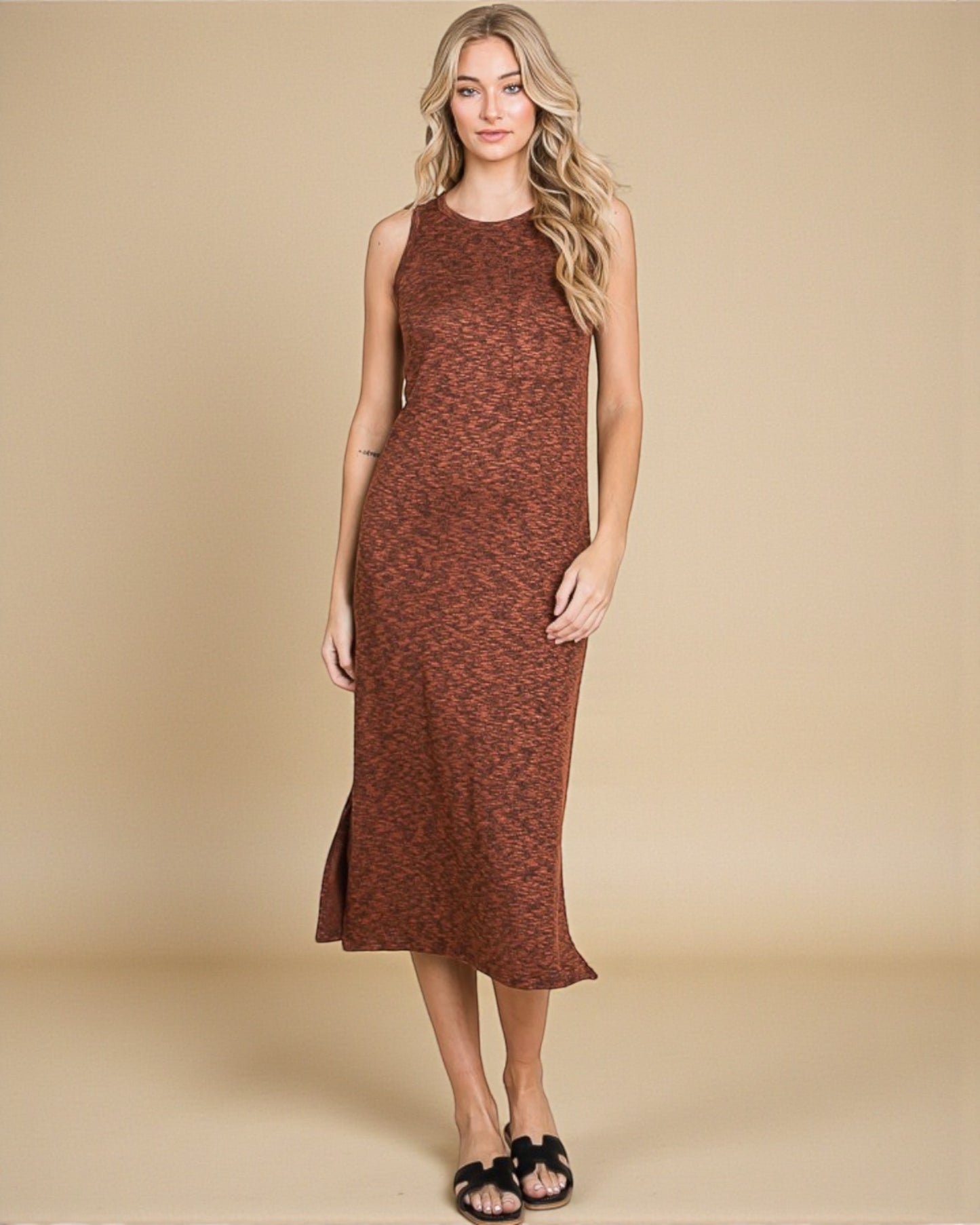 Woman wearing a brown sleeveless dress against a beige background