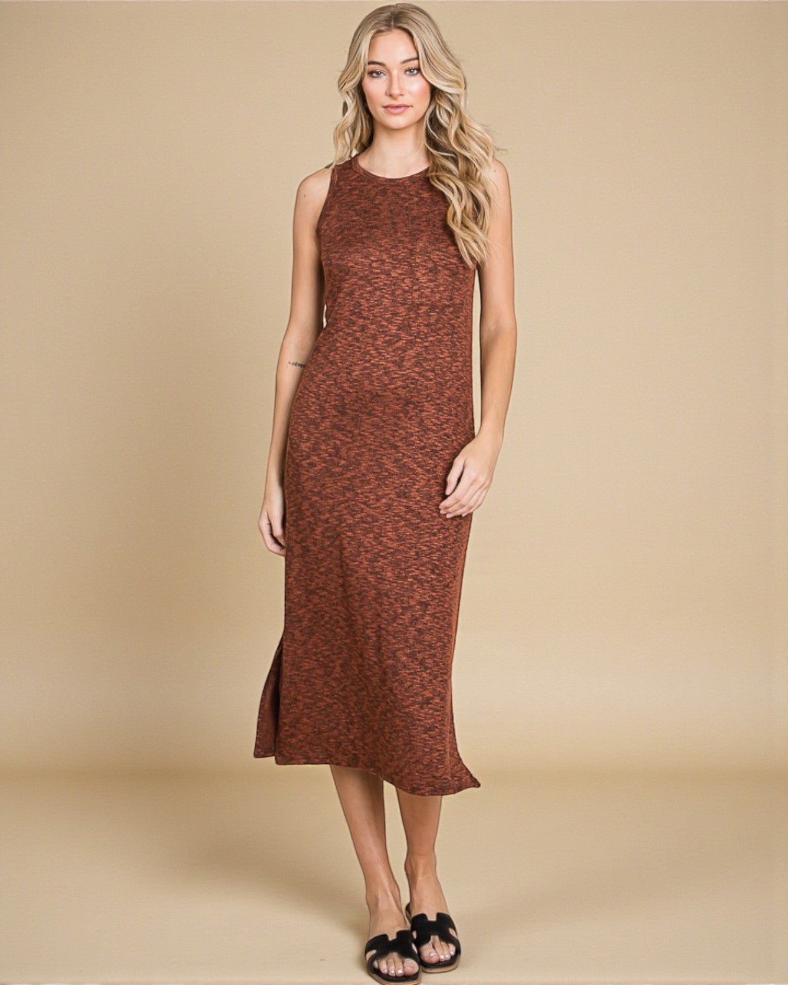 Woman wearing a brown sleeveless dress against a beige background